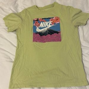Lime green Nike shirt with floral mountain design on front.